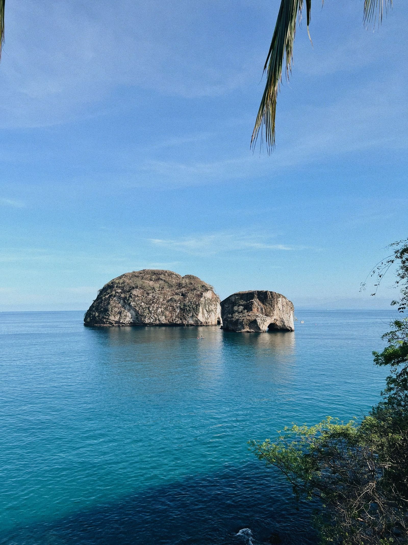 Los Arcos rock formations rising from turquoise water in Banderas Bay