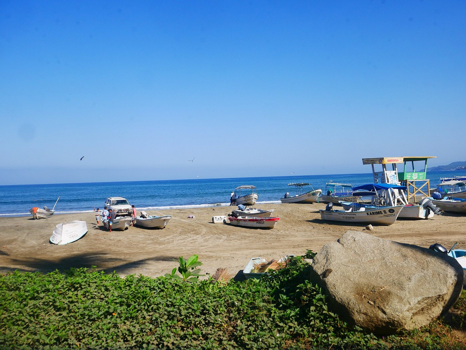 Fishing boats on the sand and a lifeguard tower on Sayulita beach