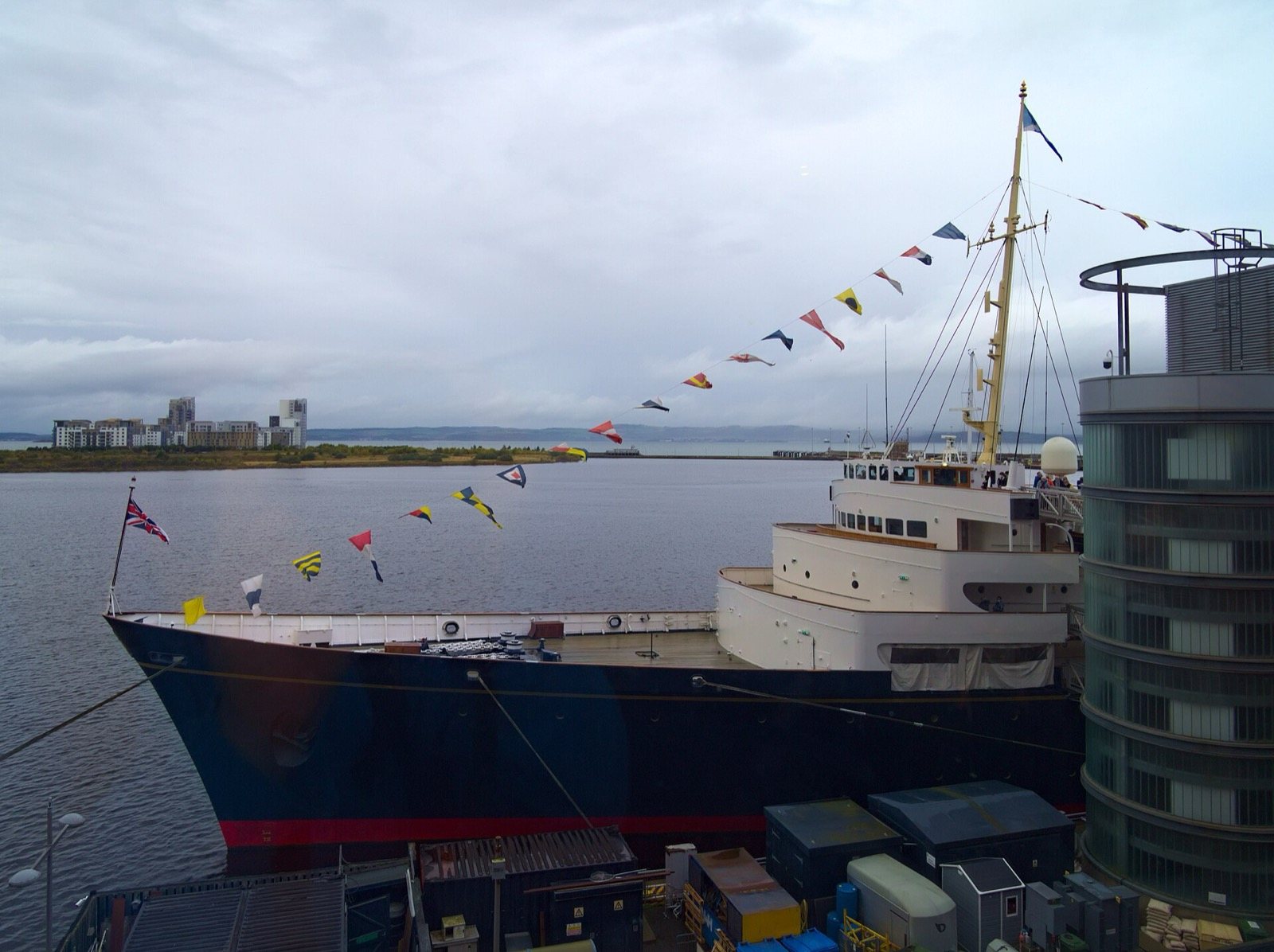Dark blue bow of the Royal Yacht Britannia moored at Leith with signal flags strung from the mast