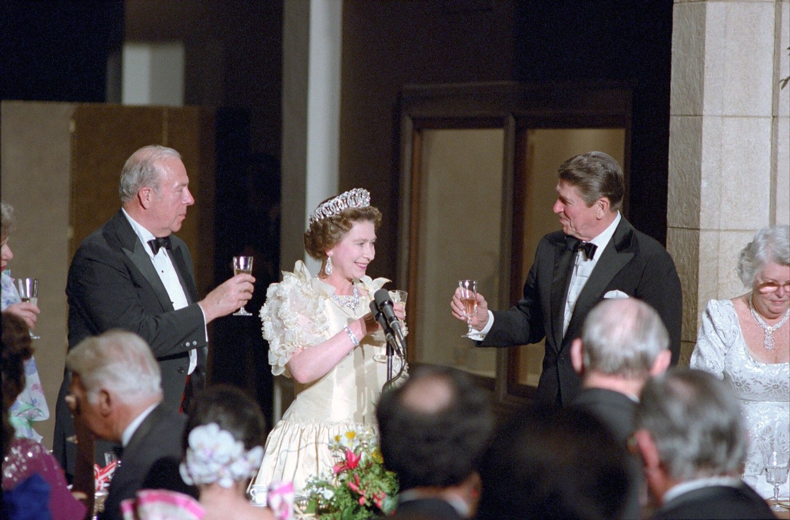 Queen Elizabeth II and President Ronald Reagan raise a toast at a formal dinner in San Francisco in 1983